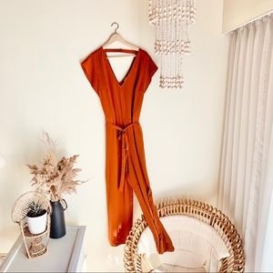 A New Day jumpsuit is burnt orange. Size XL